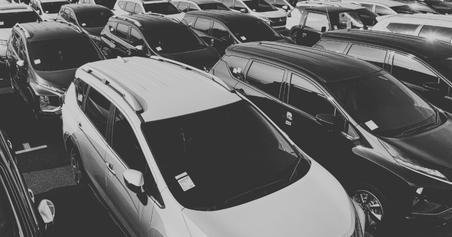 cars lined up on dealership lot