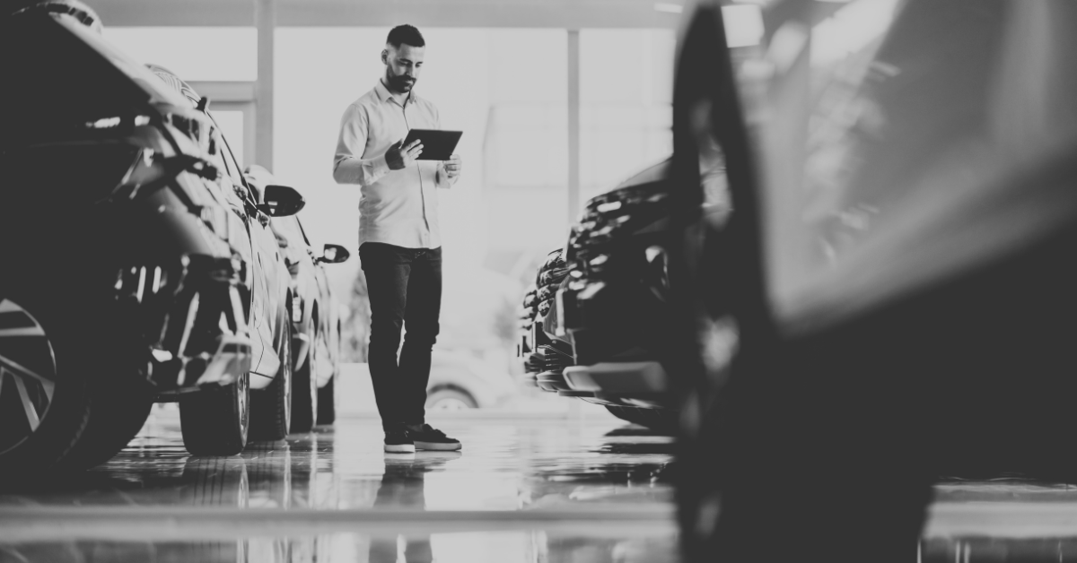car salesman looking through inventory